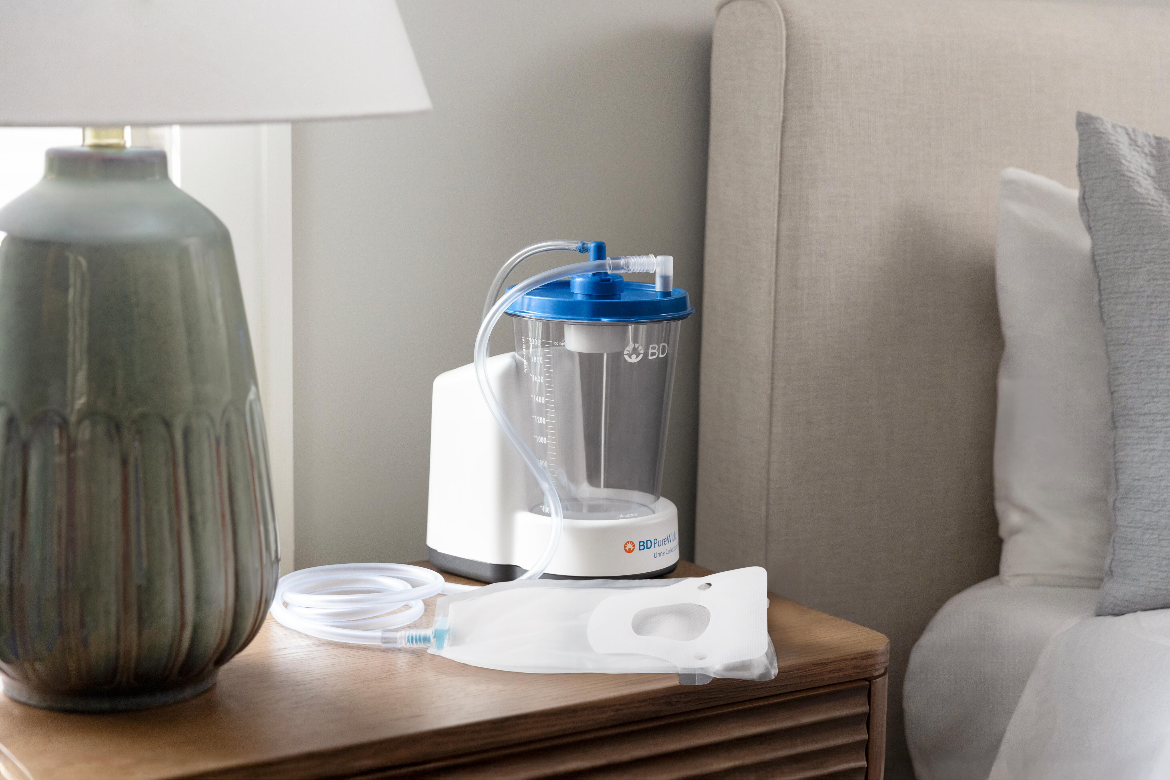 PureWick&trade; Urine Collection System with attached PureWick&trade; Male External Catheter on nightstand